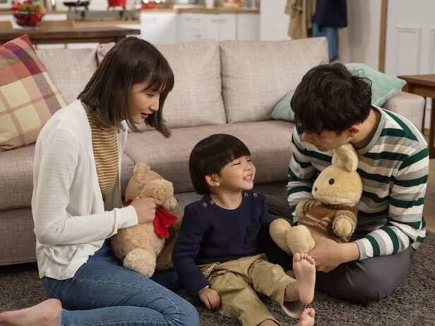 PARENTS PLAYING WITH CHILD