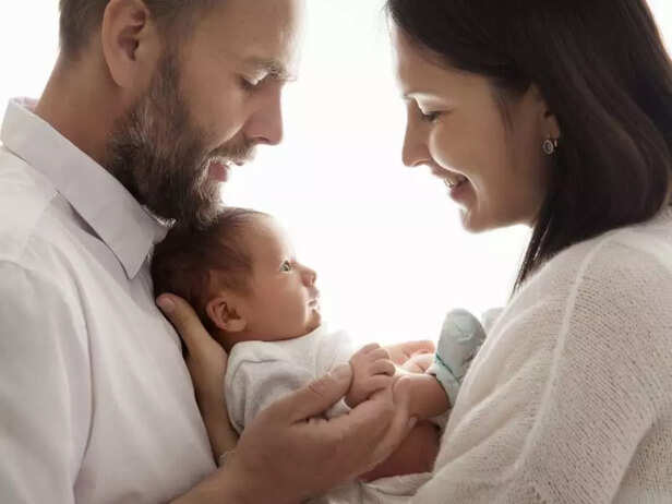 PARENTS CARRYING THEIR NEWBORN