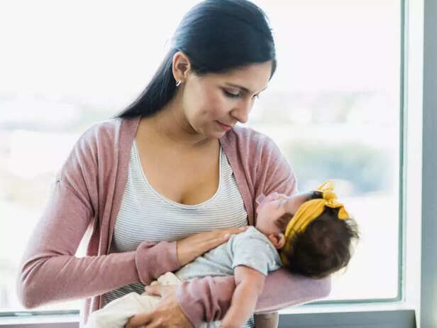 mother putting baby to sleep