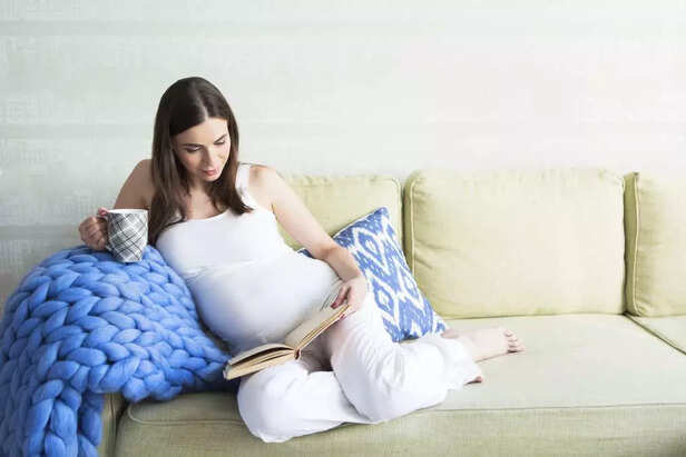 pregnant woman reading her book