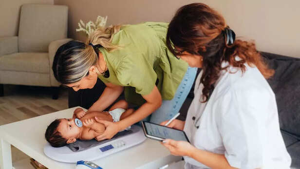doctor checking weight of the baby