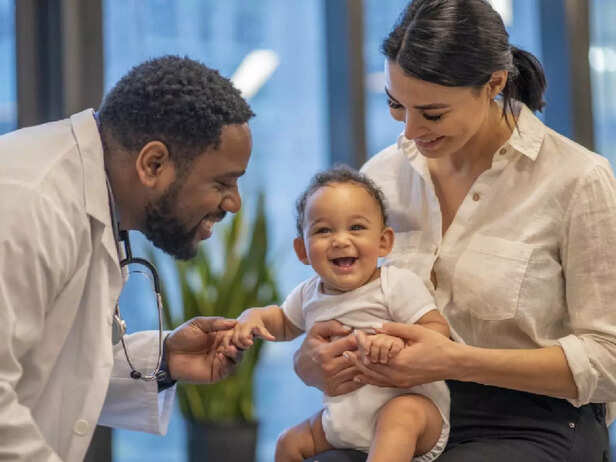 doctor with newborn and mother