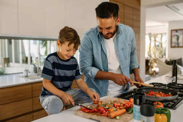 CHILD COOKING WITH FATHER
