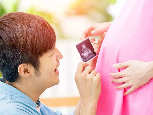 father talking to baby in womb