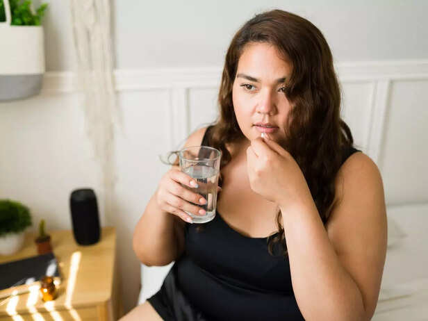overweight woman taking iron supplements