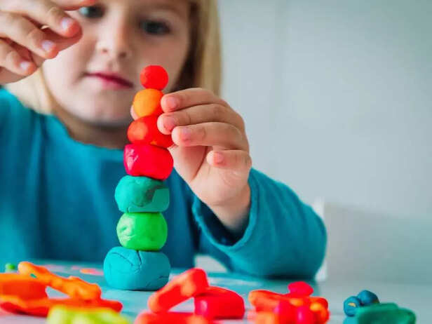 child playing with clay