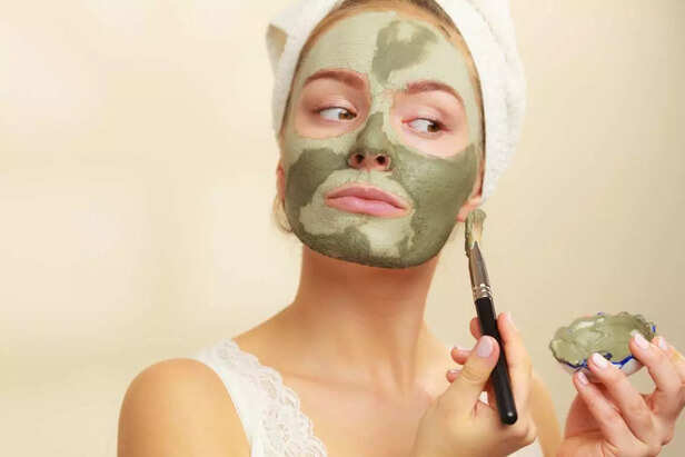 woman putting face mask