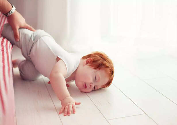 baby falling on the bed