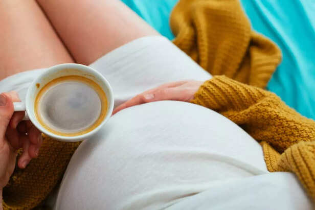 pregnant woman drinking coffee