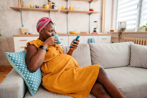 pregnant woman drinking coffee
