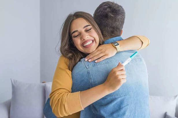 happy couple with pregnancy result