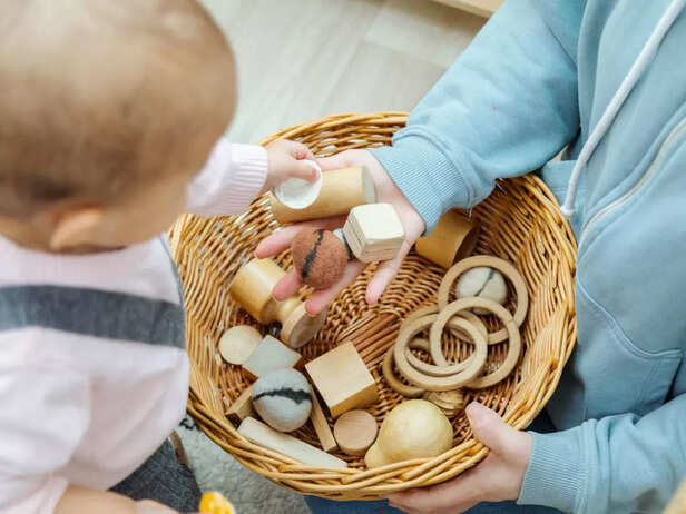 child touching different toys