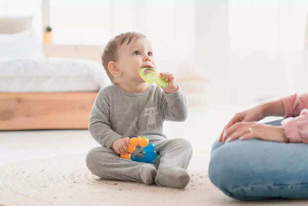 child playing with teething toy