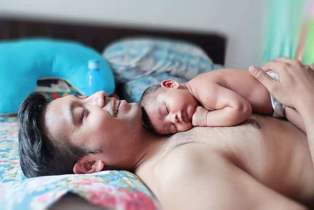 baby sleeping on father's chest
