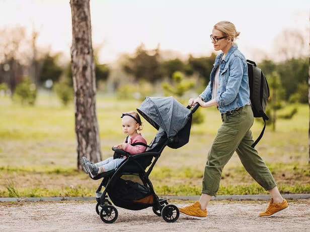 MOTHER WALKING THE BABY ON STROLLER