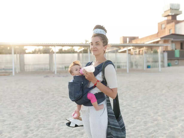 baby in baby carrier with fashionable mother