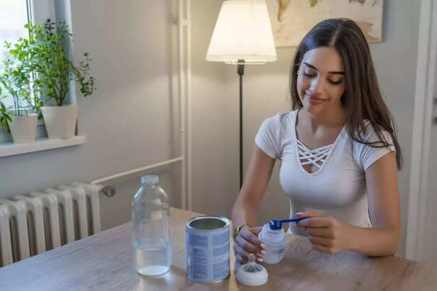 Mother prepares baby milk formula