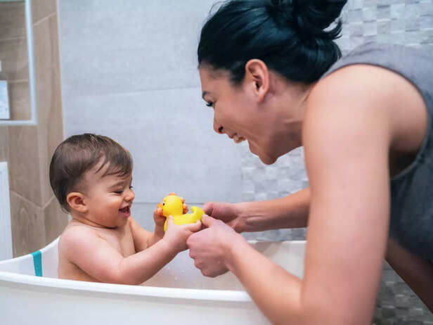 child playing with toy while bathing