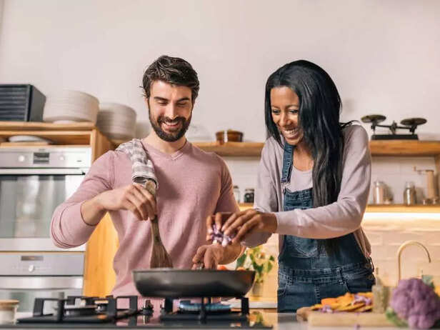 couple happily cooking together