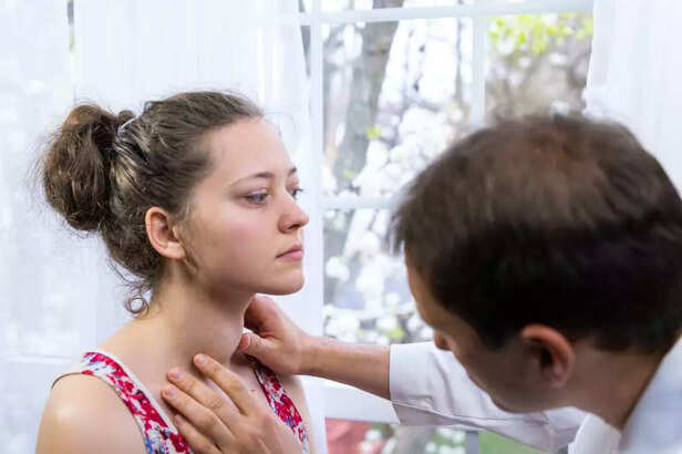 Doctor checking thyroid