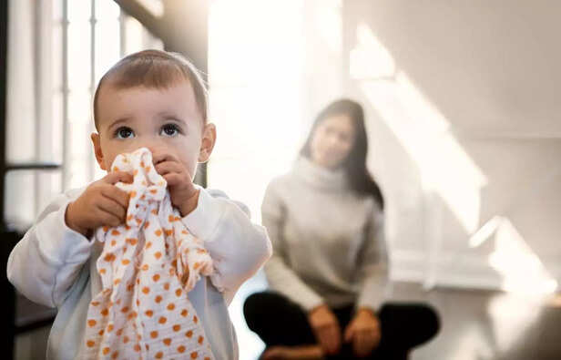 child biting a cold compress cloth