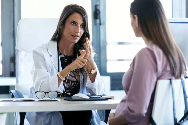 pregnant woman talking to doctor