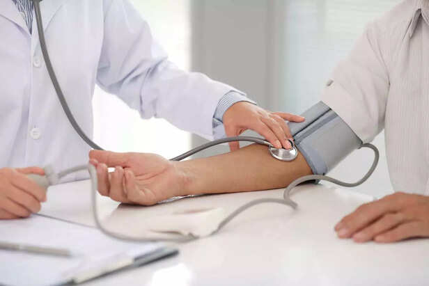 Doctor checking patients blood pressure