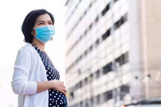 pregnant woman inhaling toxins