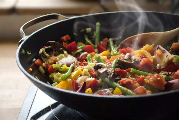 steaming mixed vegetables in the wok, asian style cooking