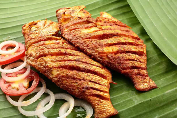 spicy seafood fish fry served on banana leaf,