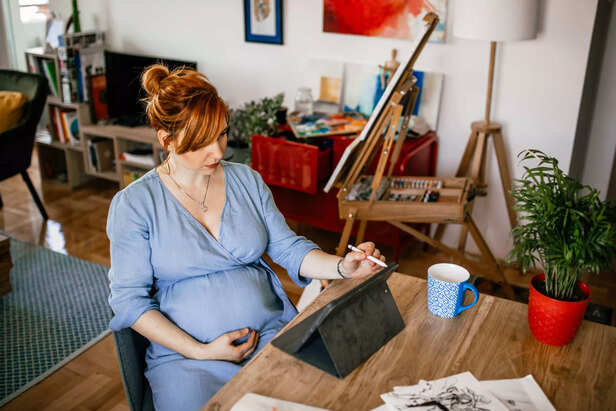 Woman artist doing artwork at home