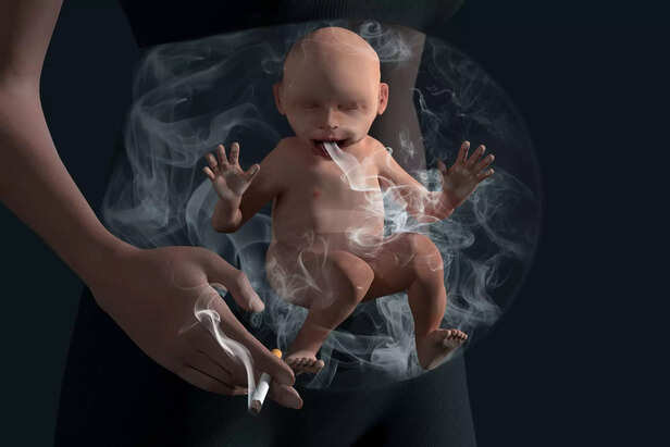 Smoking baby in baby bump. Unborn baby in baby bump smokes passively