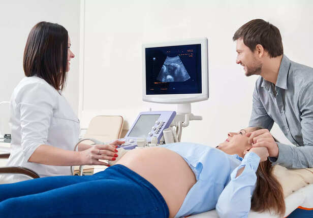 couple looking at their ultrasound