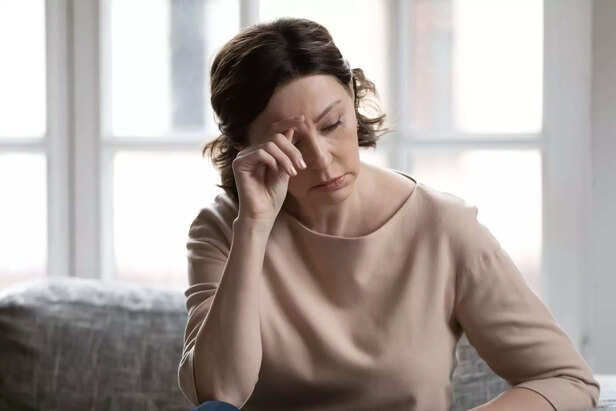 Stressed middle aged woman worrying about hard life situation.