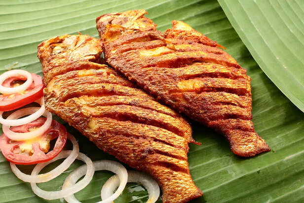 spicy seafood fish fry served on banana leaf,