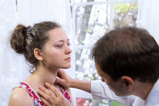 Doctor checking thyroid