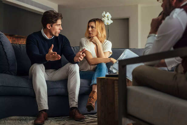 Couple arguing during therapy session with psychologist
