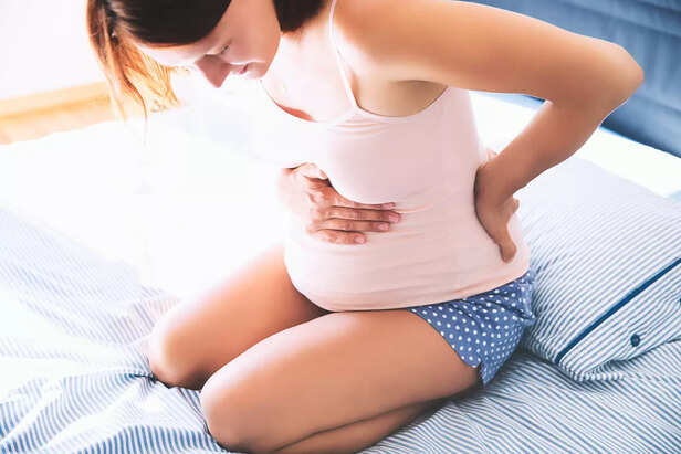 Pregnant woman suffering lower back pain.