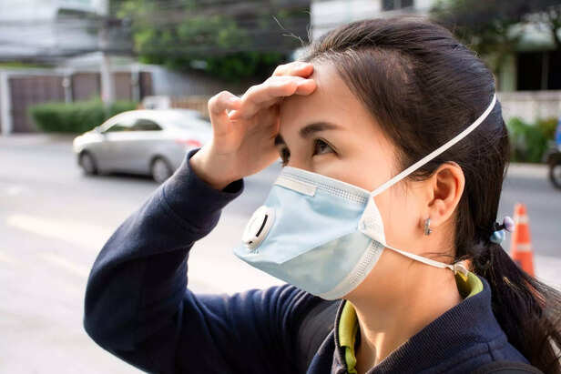 woman inhaling toxins