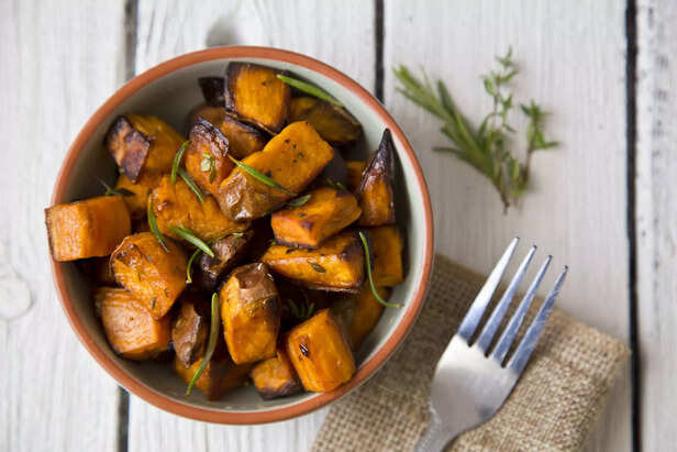 Bowl of oven roasted Sweet Potato with rosemary and thyme