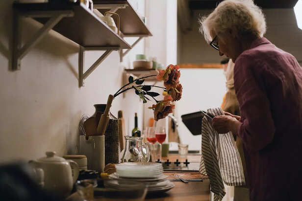 A Lady Cleaning Knife Using Cloth Towel