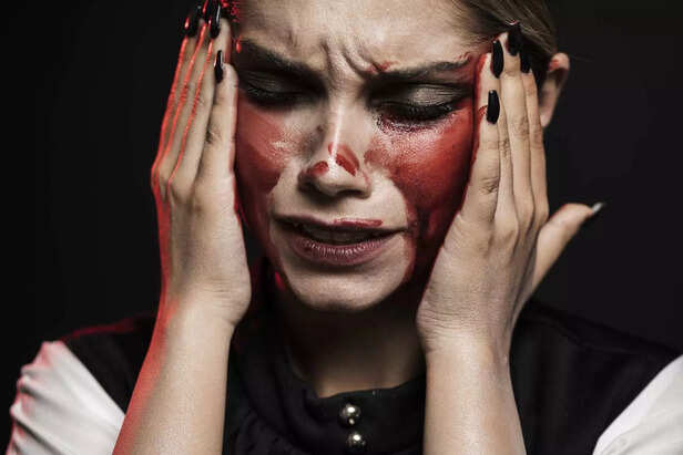 woman-with-blood holding-her-head