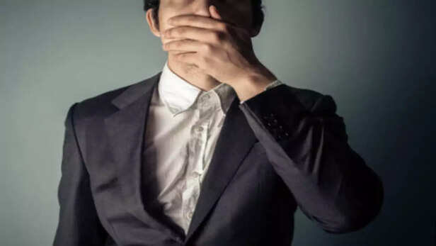 A Person Covering Their Mouth.