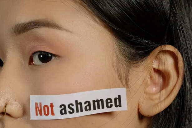 A Girl with a 'Not Ashamed' Sticker on Her Face