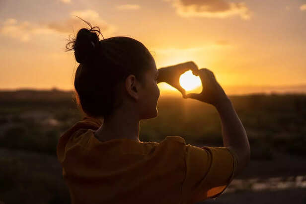 A Girl Making Heart with Hands