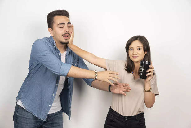 young-woman-with-black-cup-repelling-man