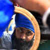 A Sikh man tying his turban.