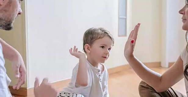 A couple playing with their child