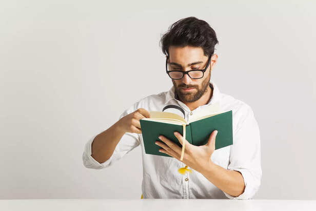 young-man-examinating-book