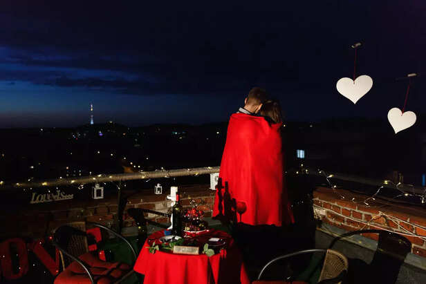 Couple at stunning rooftop Restaurant